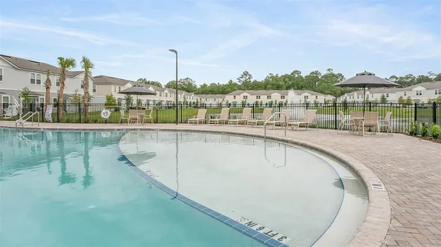 a view of a swimming pool with a patio