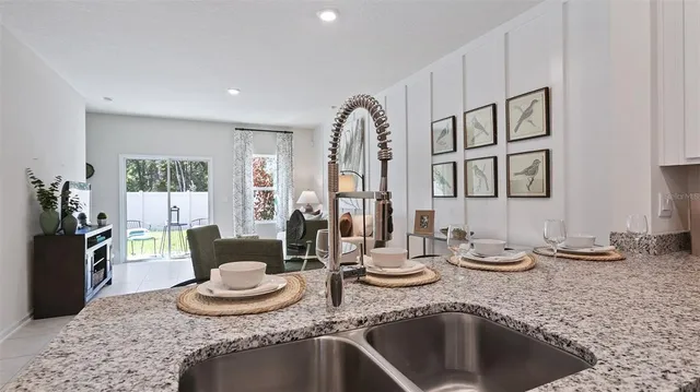 a kitchen with granite countertop a sink and a stove top oven