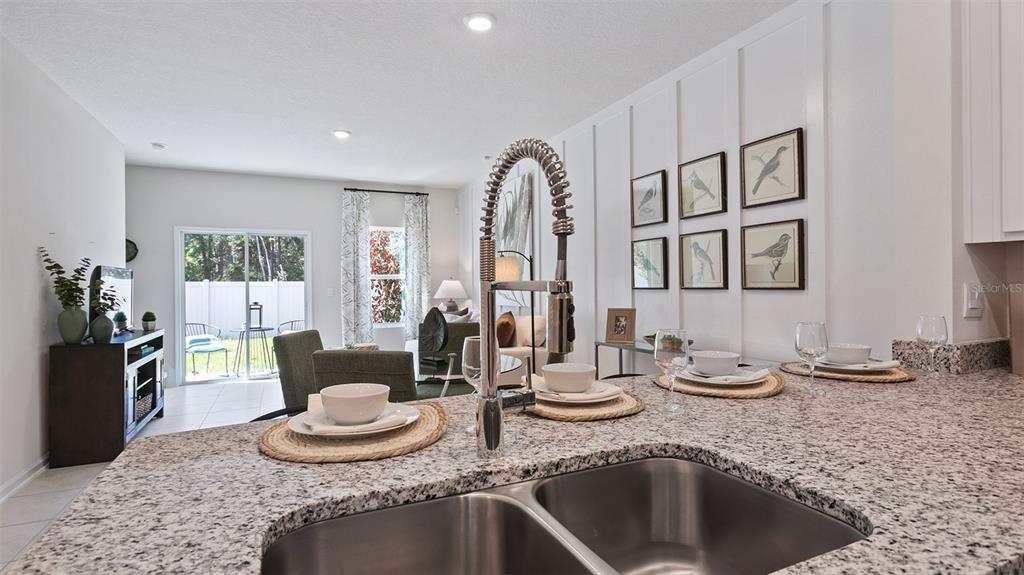 99 Blue Hvn Road St. Augustine, FL 32095 - Photo 5 of 45 a kitchen with granite countertop a sink and a stove top oven