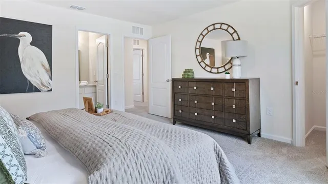 a bedroom with a bed and a dresser