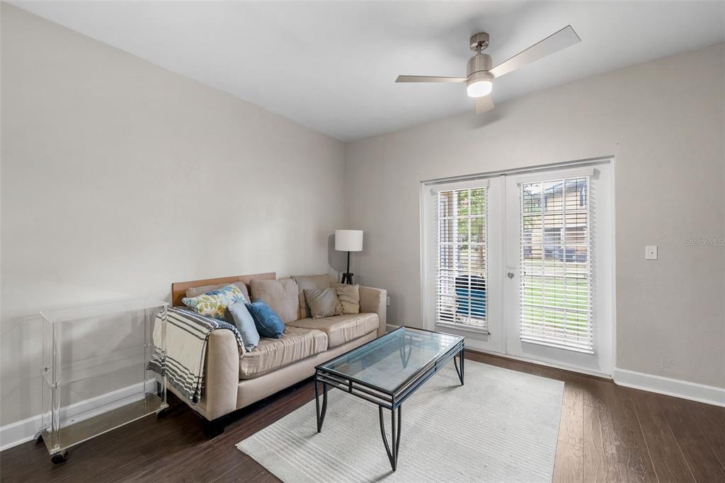 2927 Southwest 35th Place, Unit 113 Gainesville, FL 32608 - Photo 9 of 27 a living room with furniture and a window