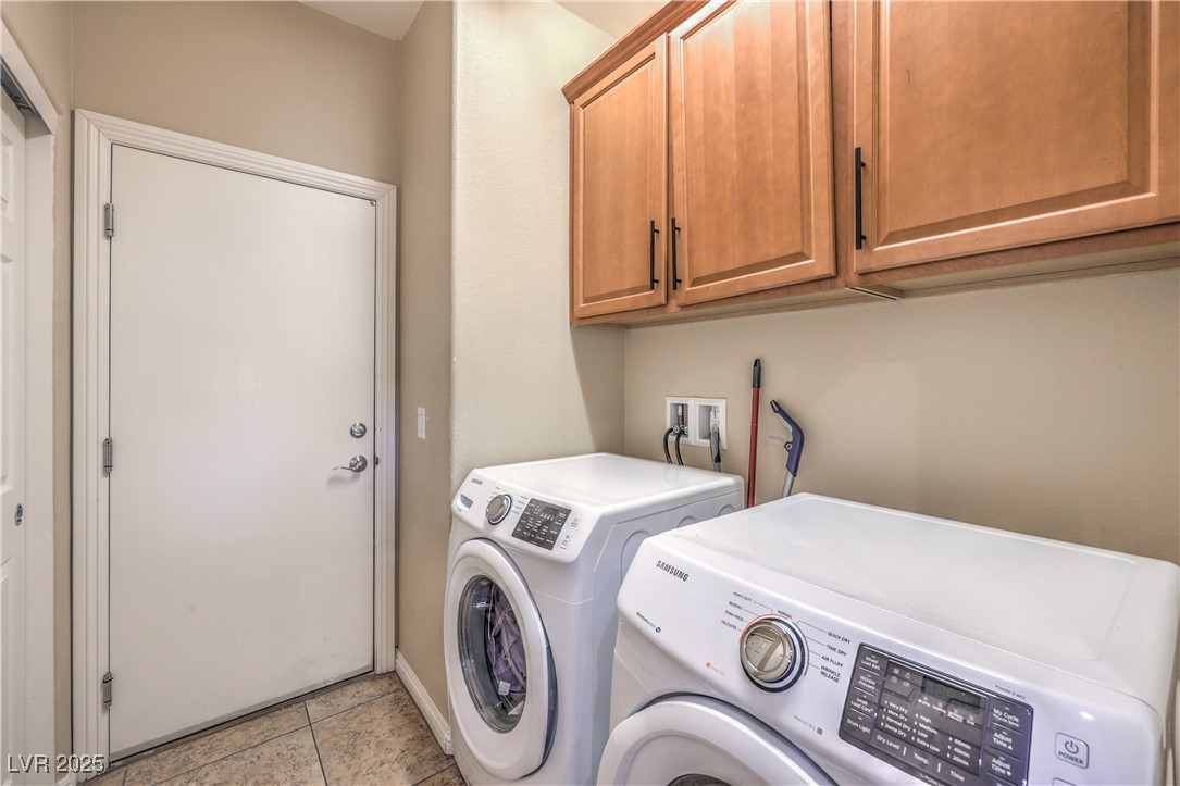 172 Turtle Ridge Avenue Las Vegas, NV 89183 - Photo 30 of 38 Washroom with light tile patterned flooring, washing machine and dryer, and cabinet space
