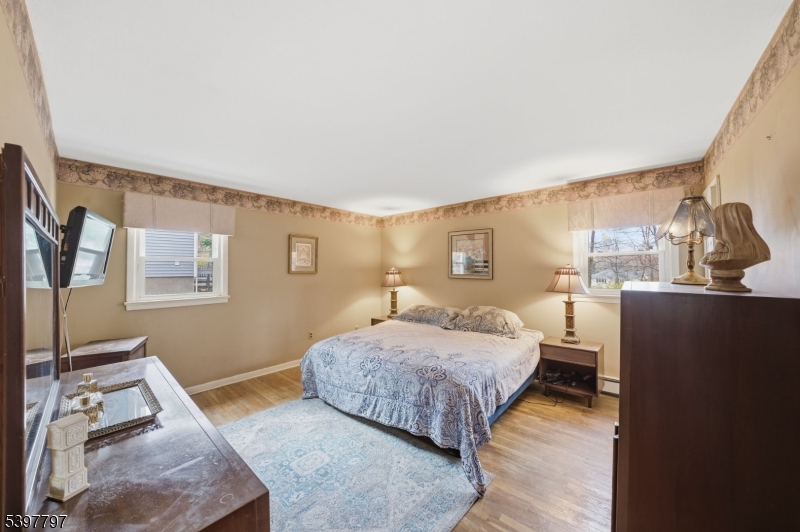 5 Glen Gate Road Boonton, NJ 07005 - Photo 15 of 46 a bedroom with a bed and wooden floor