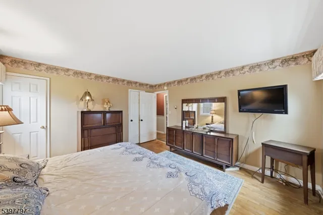 a bedroom with furniture and flat screen tv