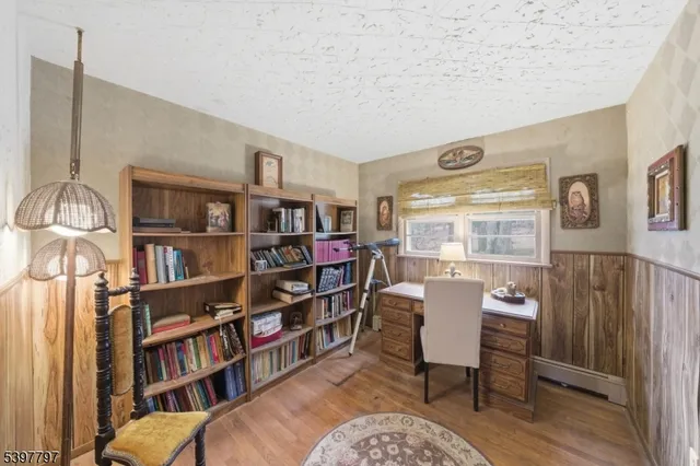 a living room with furniture and a book shelf