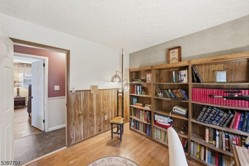 5 Glen Gate Road Boonton, NJ 07005 - Photo 19 of 46 a living room with lots of books and a book shelf