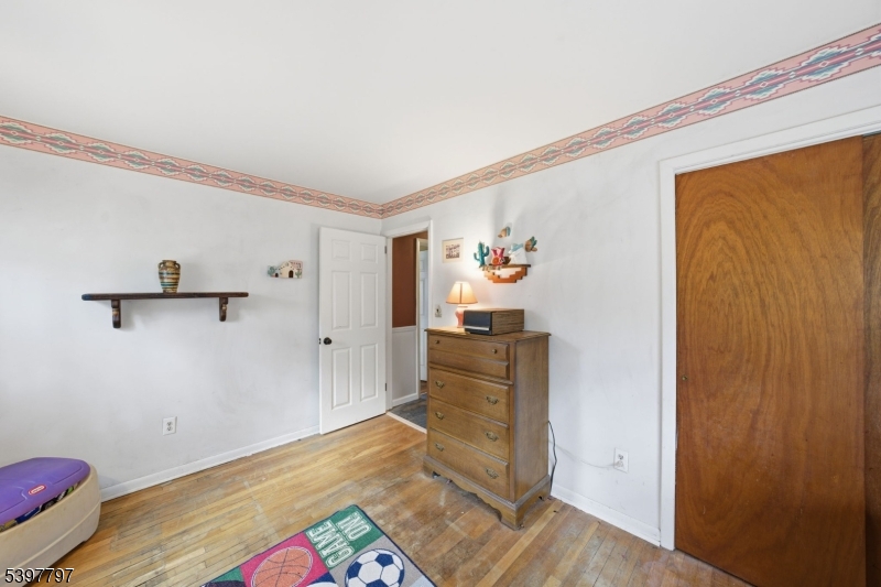 5 Glen Gate Road Boonton, NJ 07005 - Photo 21 of 46 a bedroom with a bed and wooden floor