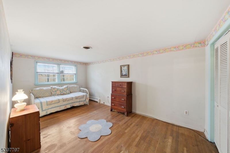 5 Glen Gate Road Boonton, NJ 07005 - Photo 28 of 46 a bedroom with a bed and wooden floor