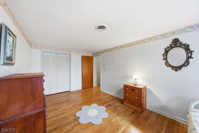 a view of room with wooden floor