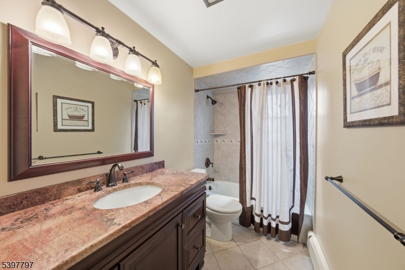 5 Glen Gate Road Boonton, NJ 07005 - Photo 31 of 46 a bathroom with a granite countertop sink a mirror a vanity and a shower