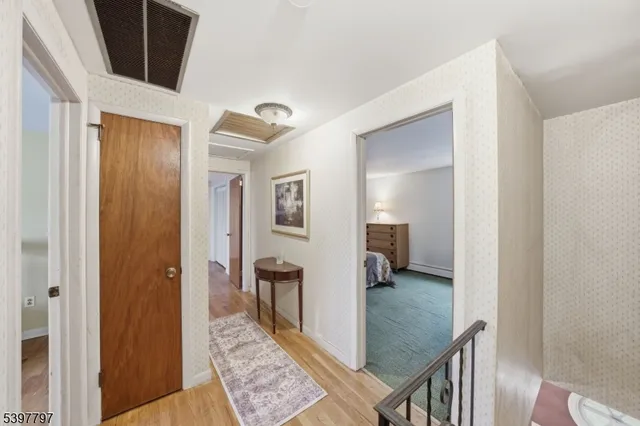 a view of a hallway with a livingroom and furniture
