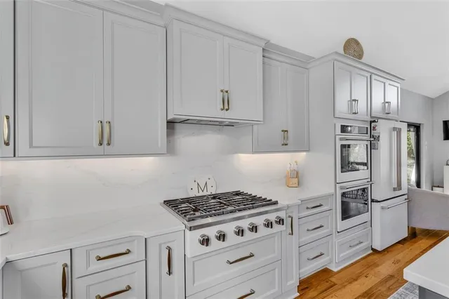 a kitchen with cabinets appliances and a counter space