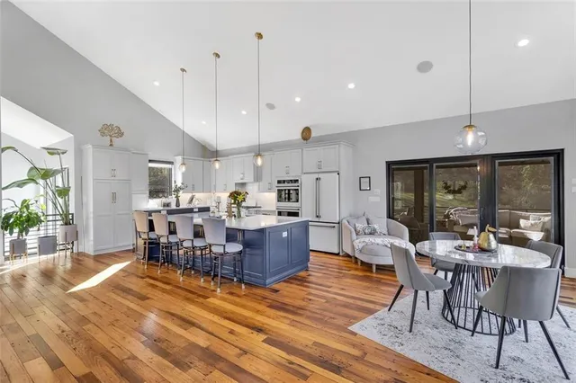a large kitchen with a table and chairs