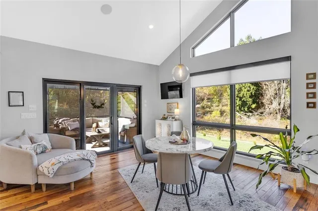 a dining room with furniture a chandelier and wooden floor