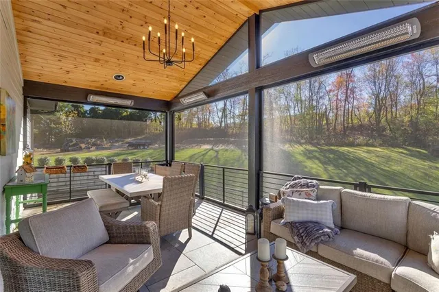 a living room with patio furniture and a floor to ceiling window