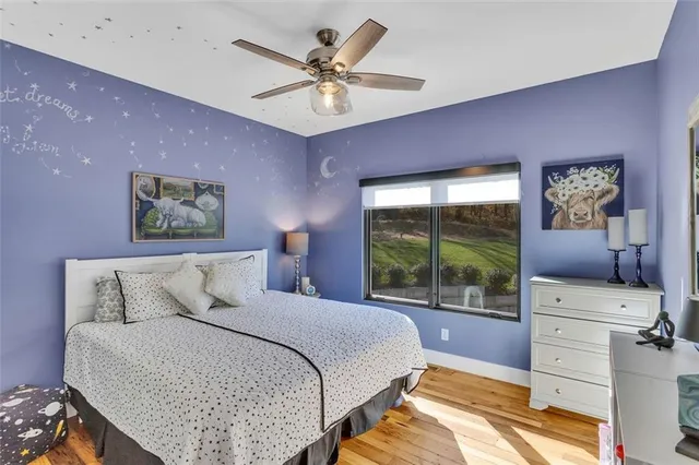 a bedroom with a large bed and a large window