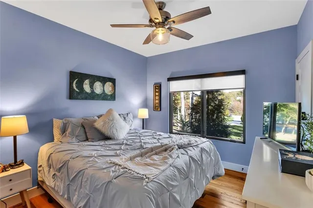 a bedroom with a bed a couch and dresser