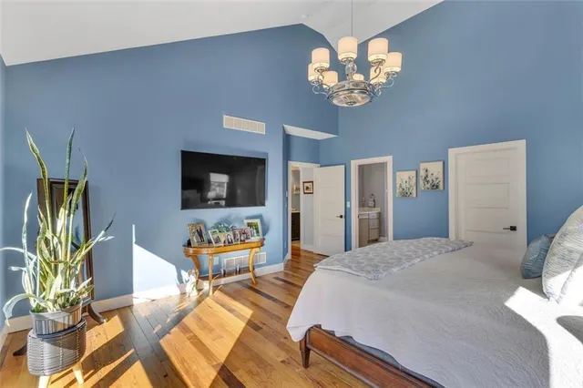 a bedroom with a bed and a chandelier