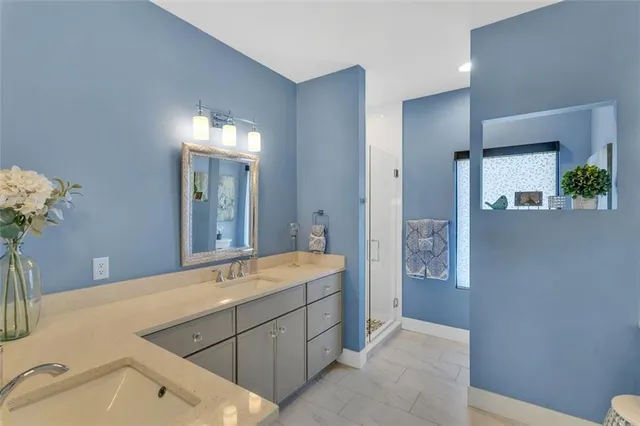 a spacious bathroom with a double vanity sink and a mirror