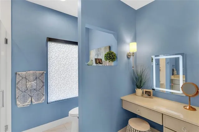 a bathroom with a toilet sink and mirror