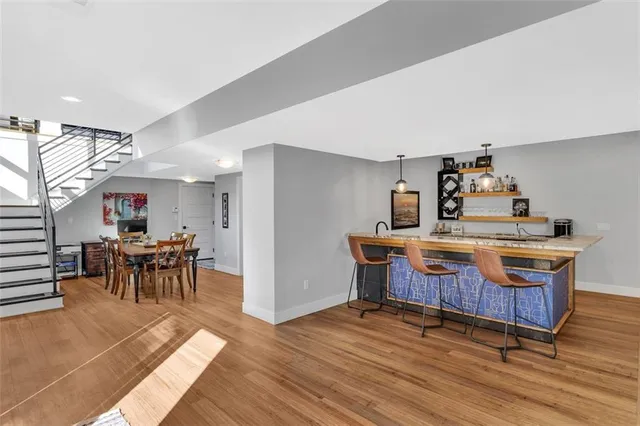 a dining room with furniture a chandelier and wooden floor