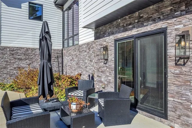 a front view of a house with outdoor seating