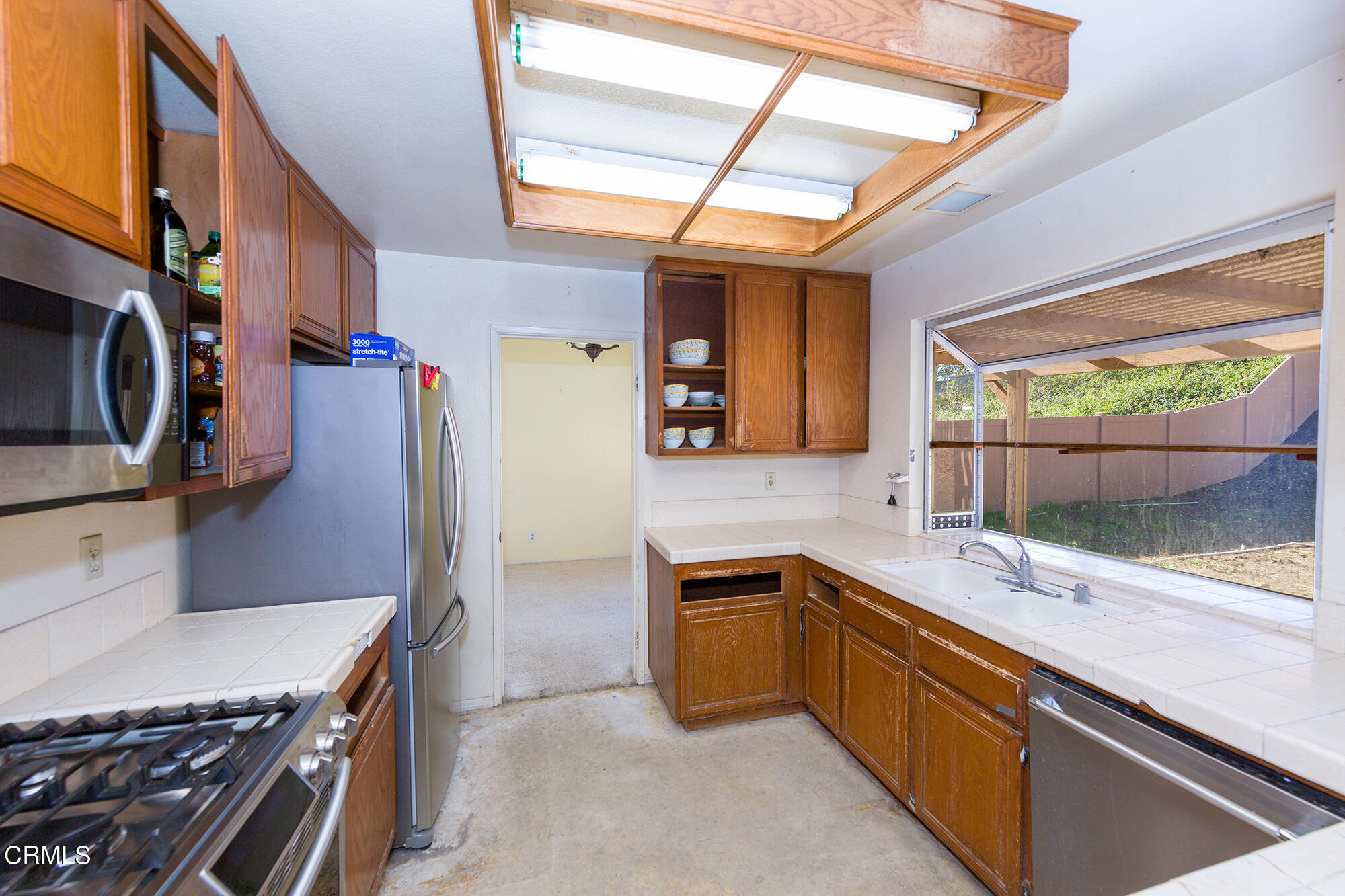 2033 Old Ranch Road Camarillo, CA 93012 - Photo 5 of 18 a kitchen that has a sink a stove and a microwave oven
