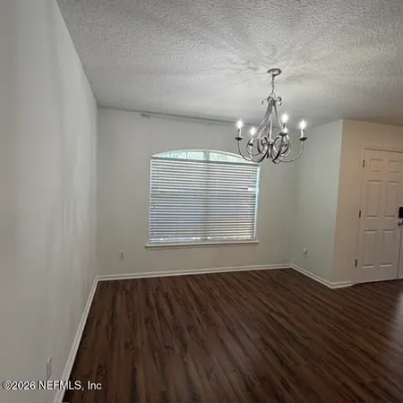 a view of a room with wooden floor and window