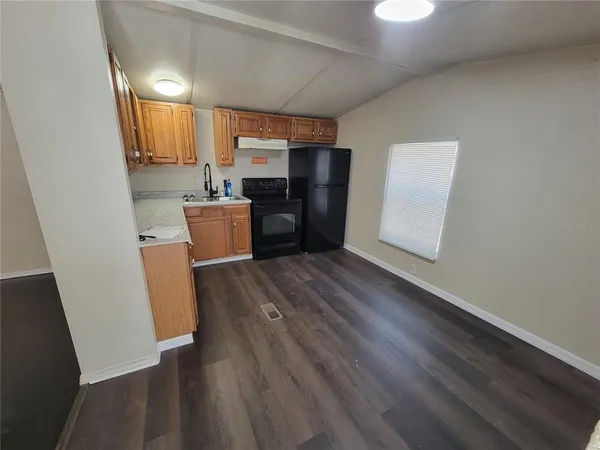 an empty room with wooden floor and a window