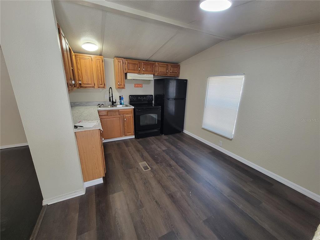 16625 Northeast 2nd Street Road Silver Springs, FL 34488 - Photo 3 of 9 an empty room with wooden floor and a window