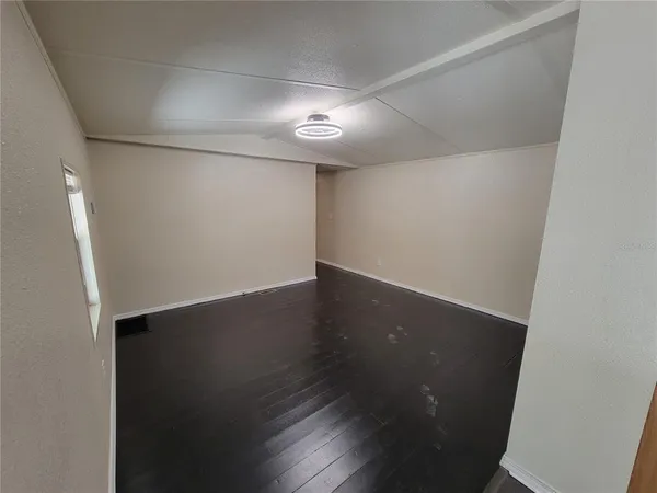 an empty room with wooden floor