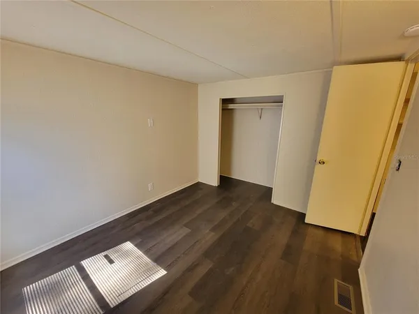 a view of an empty room and wooden floor