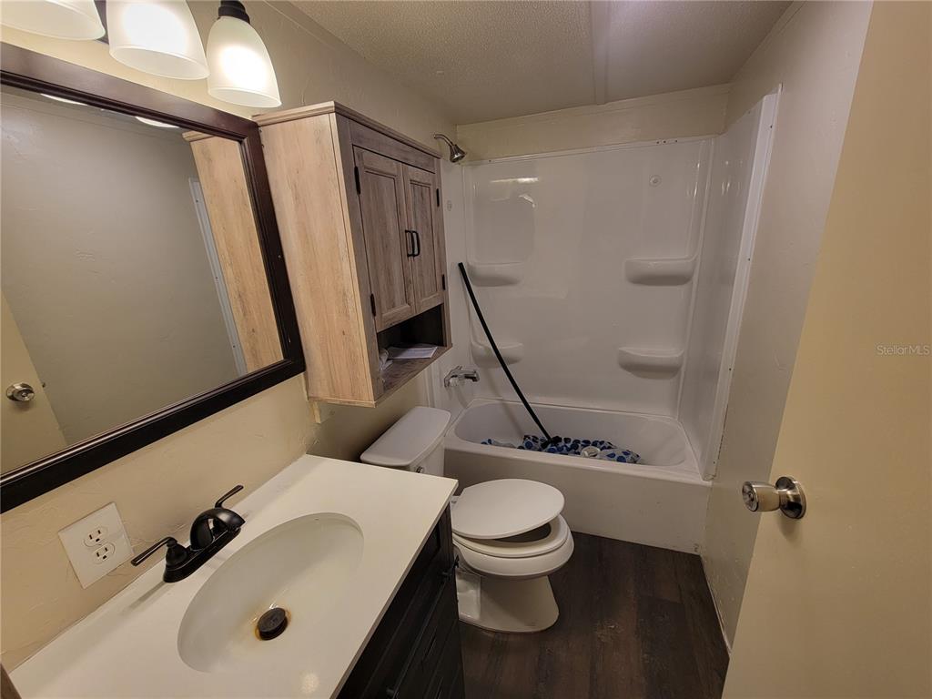 16625 Northeast 2nd Street Road Silver Springs, FL 34488 - Photo 9 of 9 a white toilet sitting next to a bathroom sink