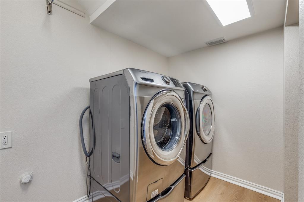 4037 Azure Lane Addison, TX 75001 - Photo 14 of 36 Washroom with wood finished floors, washer and dryer, and a textured wall