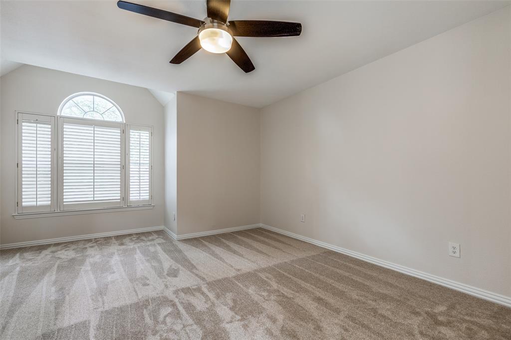 4037 Azure Lane Addison, TX 75001 - Photo 17 of 36 Carpeted empty room with vaulted ceiling and ceiling fan