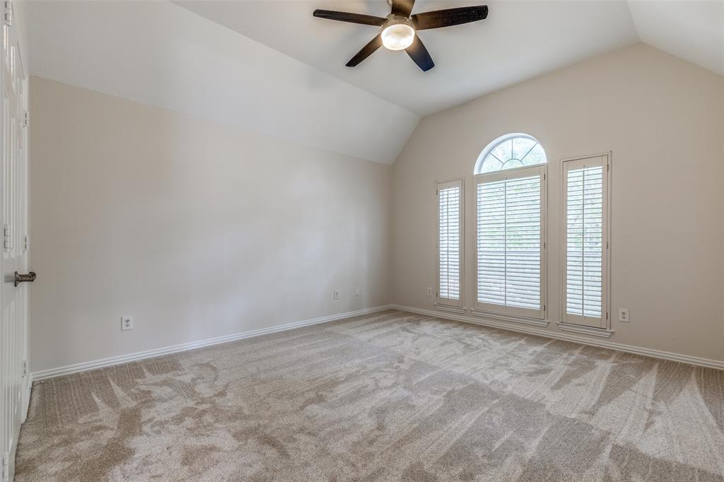 4037 Azure Lane Addison, TX 75001 - Photo 19 of 36 Spare room with lofted ceiling, light colored carpet, and ceiling fan