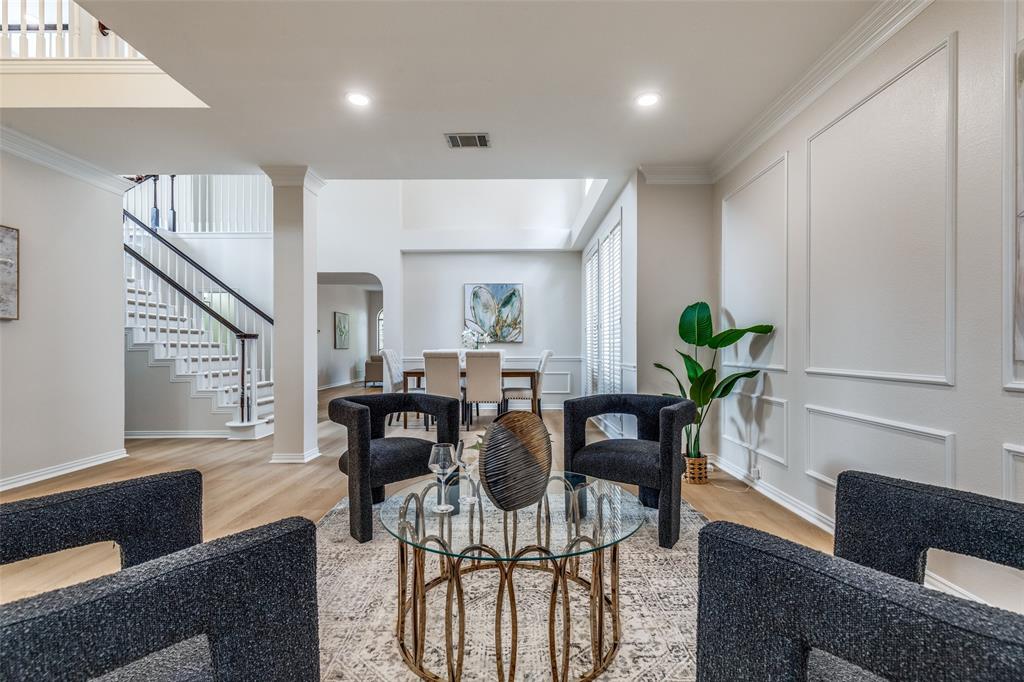 4037 Azure Lane Addison, TX 75001 - Photo 2 of 36 Living area featuring ornamental molding, arched walkways, light wood finished floors, stairs, and recessed lighting