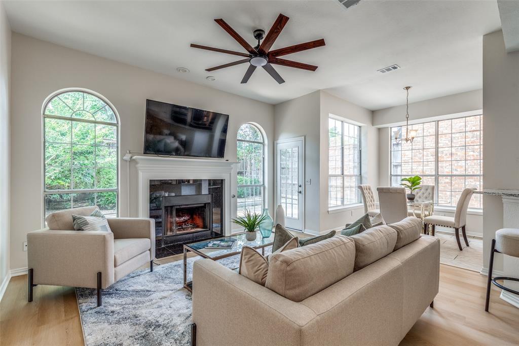 4037 Azure Lane Addison, TX 75001 - Photo 4 of 36 Living room with light wood finished floors, plenty of natural light, and ceiling fan
