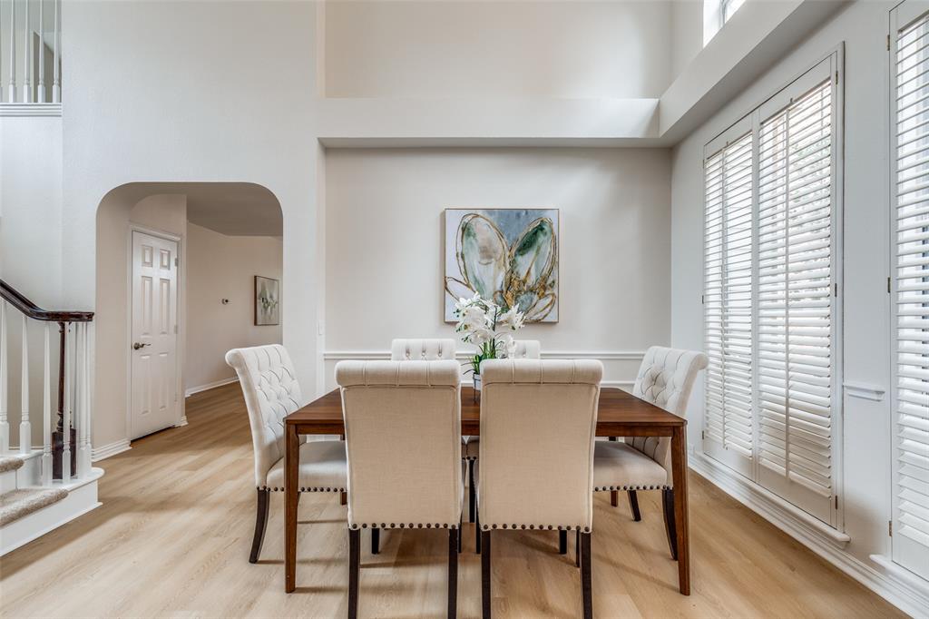 4037 Azure Lane Addison, TX 75001 - Photo 6 of 36 Dining area featuring stairs, arched walkways, light wood-style flooring, and a high ceiling
