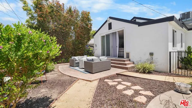 a view of a chair and table in backyard