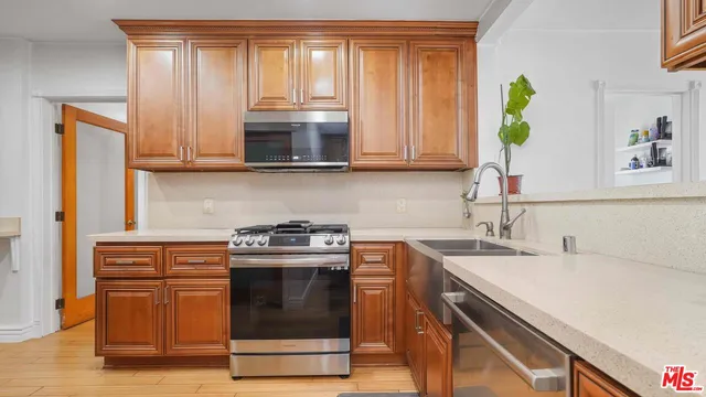 a kitchen with a stove a sink and a microwave