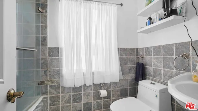 a bathroom with a toilet and a shower