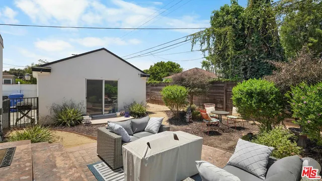 a view of backyard of house with outdoor seating
