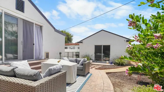 a balcony with furniture and flowers
