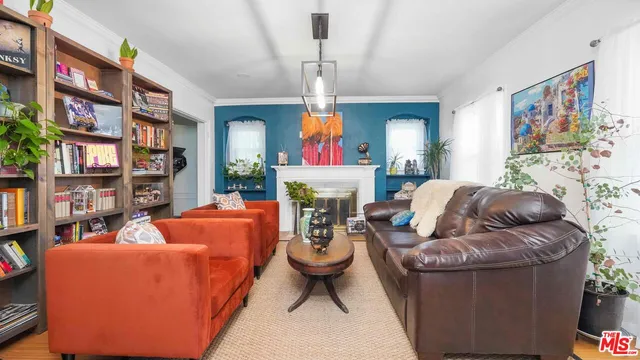 a living room with fireplace furniture and a chandelier