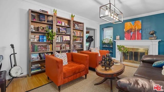 a living room with fireplace furniture and a chandelier