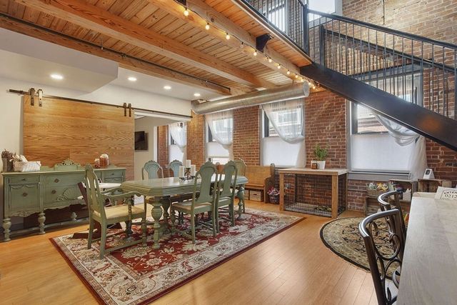 a view of a dining room with furniture and a potted plant