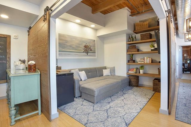 a bedroom with furniture and a large window