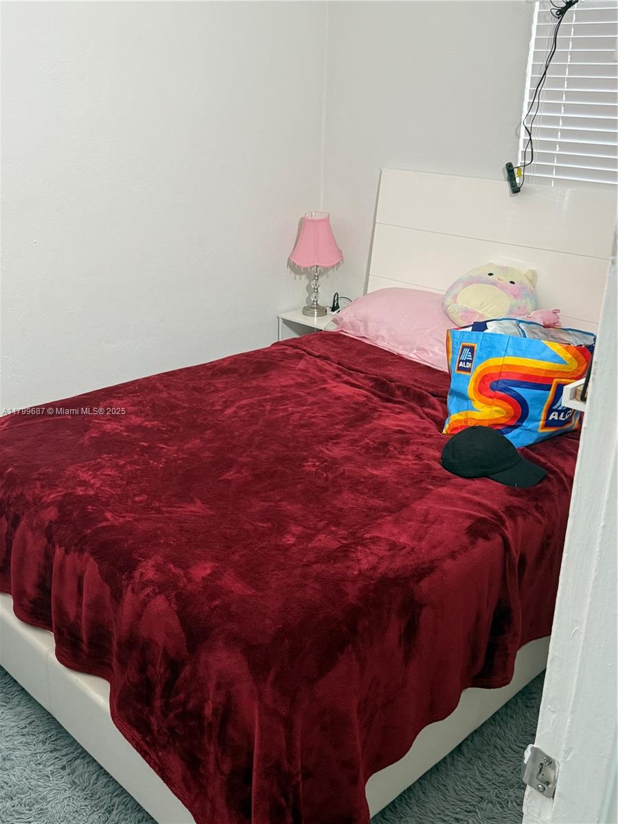 2340 Service Road Opa-Locka, FL 33054 - Photo 15 of 29 a bedroom with a bed and painting on the wall