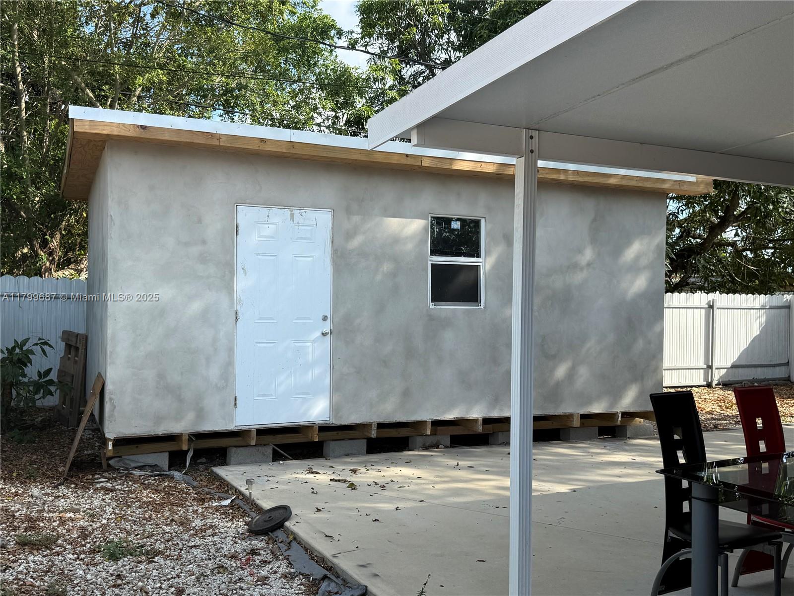 2340 Service Road Opa-Locka, FL 33054 - Photo 20 of 29 a front view of a house with trees
